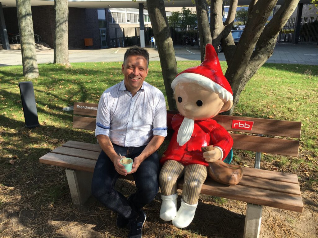 Simplexity team member on a bench on a broadcaster’s campus
